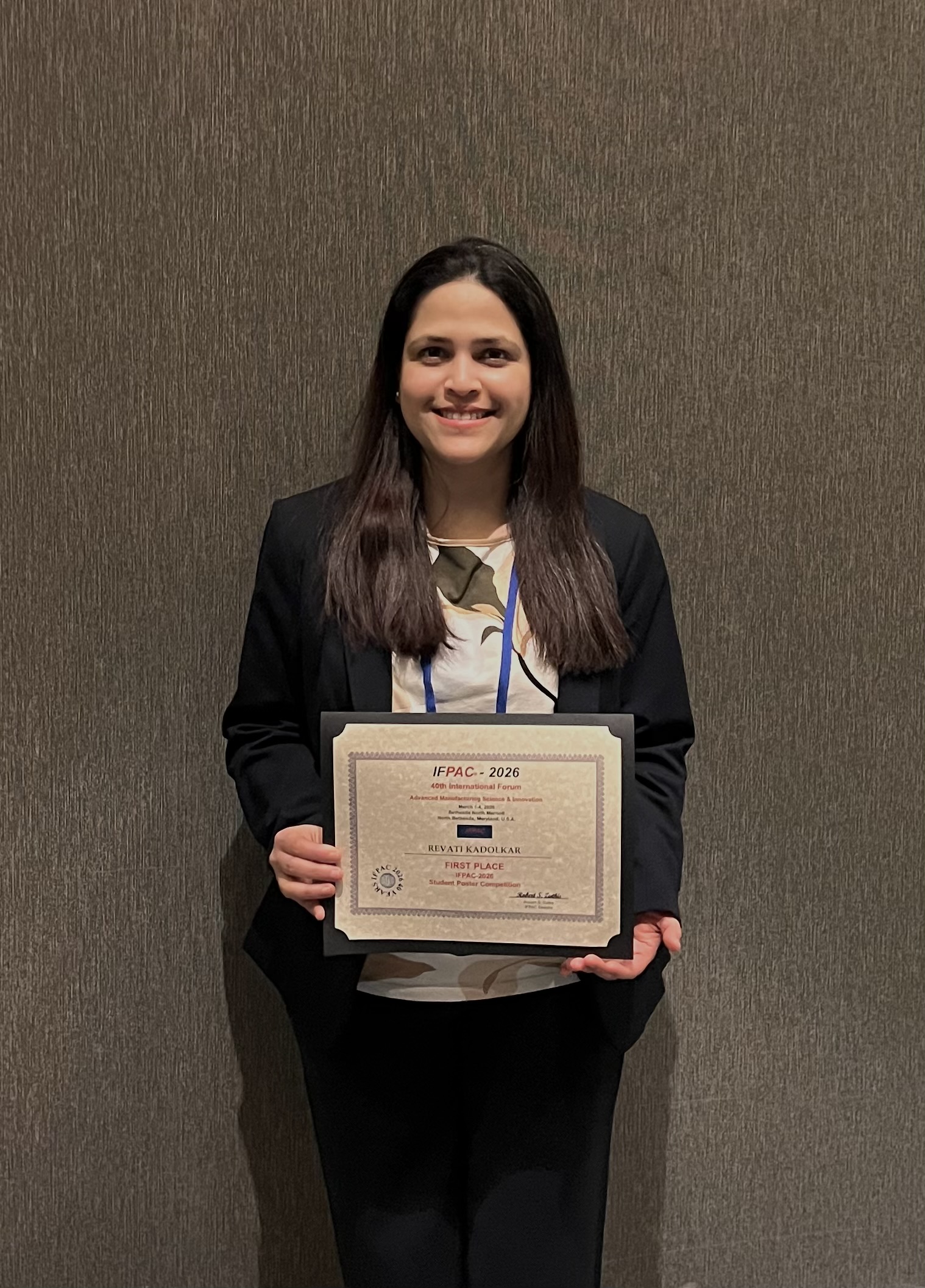 Revati Kadolkar holds her first-place award certificate.